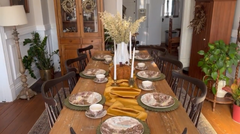 Harvest table setup for a Thanksgiving dinner party