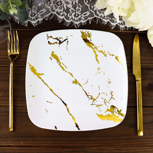 Square white plate with gold marbling design, styled with gold cutlery.