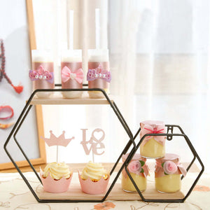 Decorative dessert display with cupcakes and layered treats in a stylish stand.
