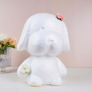 White dog-shaped figurine with floral accents on a soft pink backdrop.