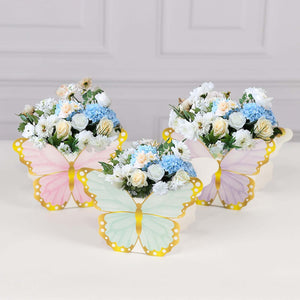Colorful butterfly-shaped flower arrangements in pastel colors.