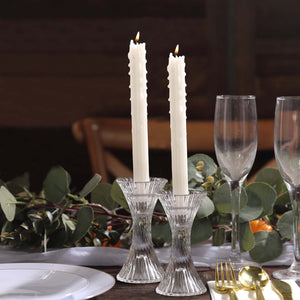 Elegant crystal candle holders with white candles, perfect for dining decor.