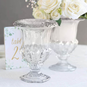 Clear decorative vase with intricate design, perfect for floral arrangements.