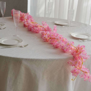 Pink floral table runner on an elegant dining table setting.