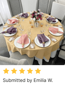 Table setting by Emilia W with tablecloth, table overlay, napkins, plates, cutlery, candles, table number, and flower centerpiece