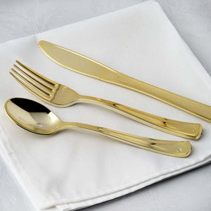 Gold cutlery set on a white napkin.