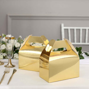 Gold gift boxes on a table with elegant decor and tableware.