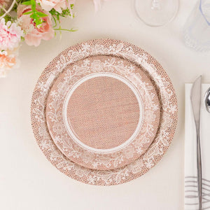 Decorative pink plate with floral design on a table setting.