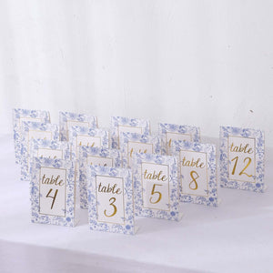 Floral table numbers for wedding or event decor, featuring gold lettering.