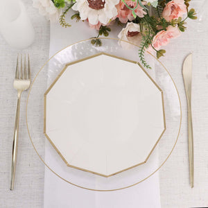 Elegant octagonal white plate with gold trim on a dining table setting.