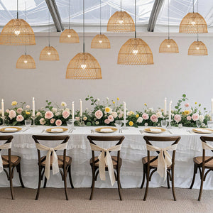 Elegant dining setup with floral centerpieces and pendant lighting.