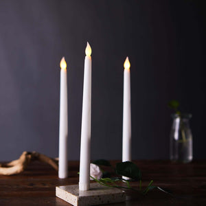 White LED candles with flame effect on a decorative holder.