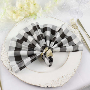 Black and white checkered napkin elegantly folded on a decorative plate.