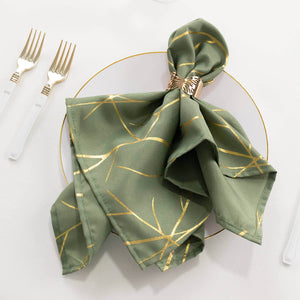 Green patterned napkin elegantly styled on a decorative plate with cutlery.