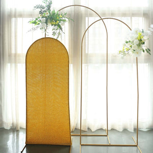 Gold arch backdrop with floral arrangements for events or photography.
