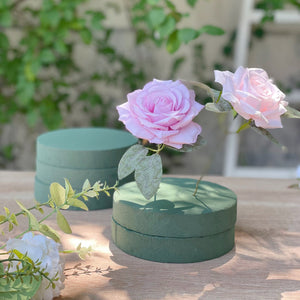 Pink roses with green bases on a natural background, showcasing elegant floral arrangement.