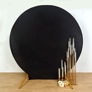 Gold candle holders arranged beside a black backdrop, showcasing elegant design.