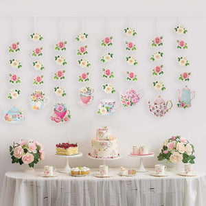 Tea party decorations with floral motifs and a dessert table setup.
