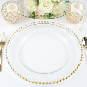 Elegant clear plate with gold beaded rim, styled with candles and flowers.