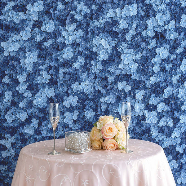Blue floral wall backdrop with pink table setting and champagne flutes