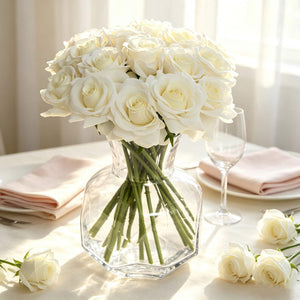 White rose bouquet in glass vase on elegant table setting