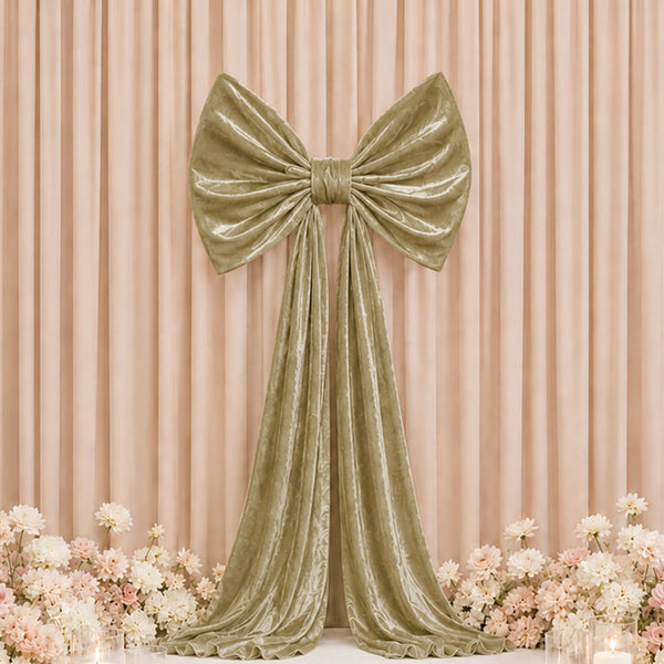 Elegant gold velvet bow drape backdrop with pastel flowers for event decor