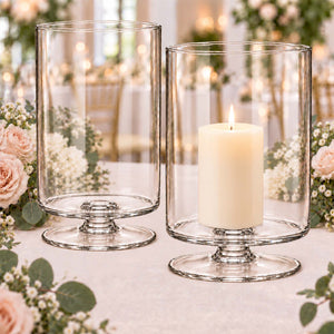 Clear glass hurricane candle holders with pillar candle and floral decor