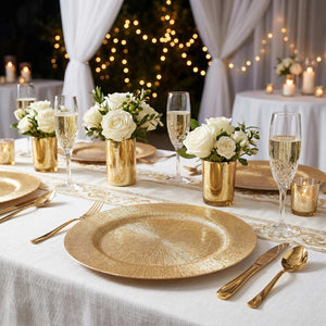 Elegant gold and white wedding table setting with roses and candles