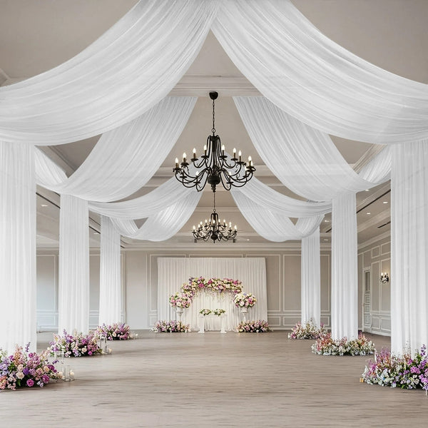 Elegant wedding venue with draped fabric and floral arrangements.