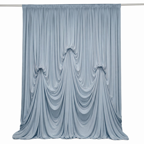 Light blue draped curtain backdrop on rod, elegant fabric folds