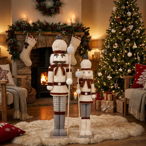 Festive Christmas living room with tree, fireplace, stockings, and nutcracker décor
