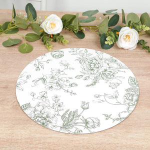 Floral design round placemat on a wooden table with greenery accents.