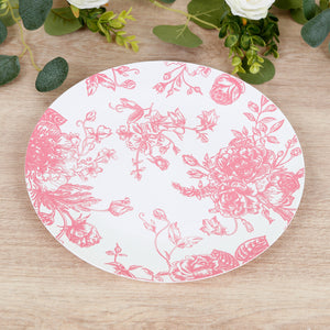 Floral design pink plate on wooden table surface.