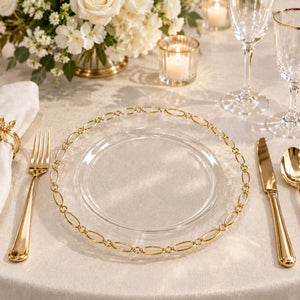 Elegant gold and glass wedding table setting with floral centerpiece and candles