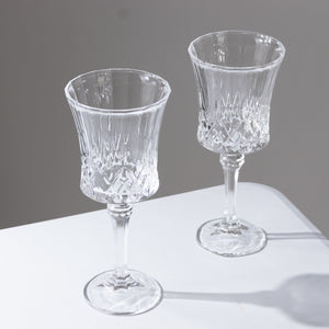 Elegant crystal wine glasses on a minimalistic table.