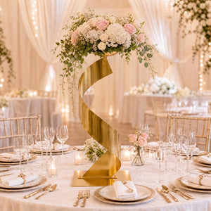 Luxury wedding table centerpiece with gold stand, pink roses, and white florals