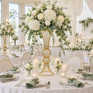 Elegant white and green wedding reception table with floral centerpiece and candles