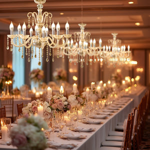Elegant chandelier lighting over a beautifully arranged dining table in a luxurious setting.