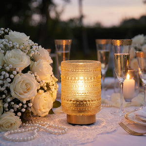Elegant wedding table setting with white roses, candles, and champagne flutes