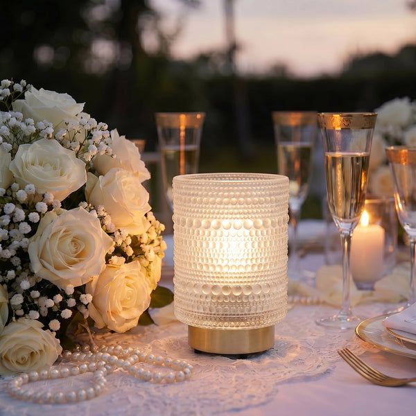 Elegant wedding table setting with white roses, candles, and champagne glasses