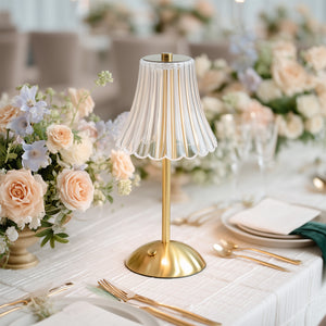 Elegant gold table lamp with pleated glass shade at a floral wedding table centerpiece