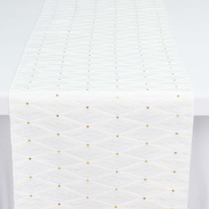 White woven ribbon with gold dotted pattern close-up