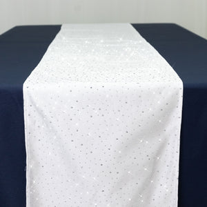 White table runner with silver sparkles on a navy blue table.