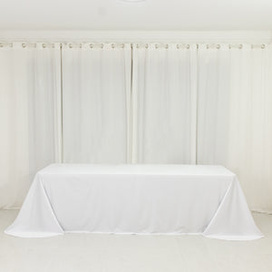 White tablecloth draped over a table in a bright, airy room.