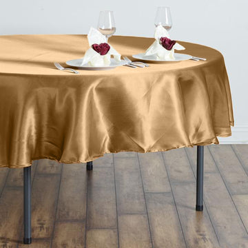 Create a Festive Ambiance with our Gold Seamless Satin Round Tablecloth