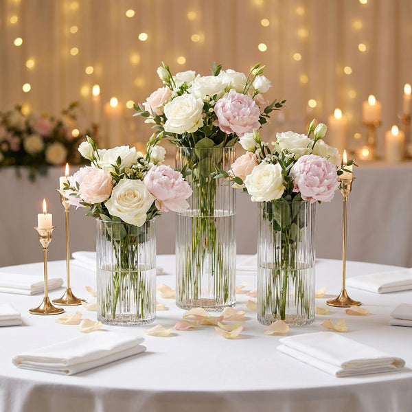 Elegant wedding table centerpiece with pastel roses, candles, and fairy lights