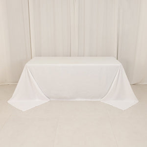 White tablecloth draped over a table in a studio setting.