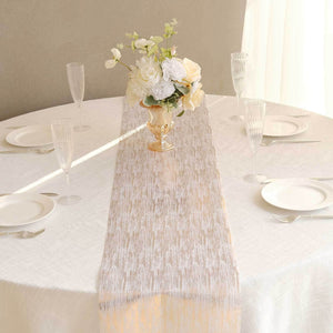 Elegant table setting with floral centerpiece and white table runner.