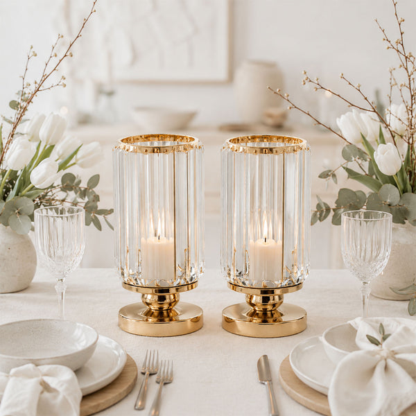 Elegant gold and glass candle holders with white floral table setting