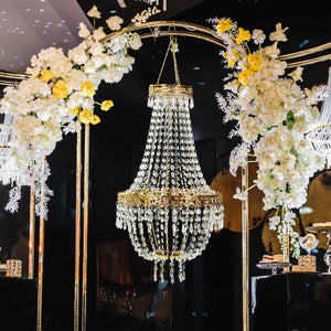 Elegant crystal chandelier adorned with flowers, showcasing a luxurious design.